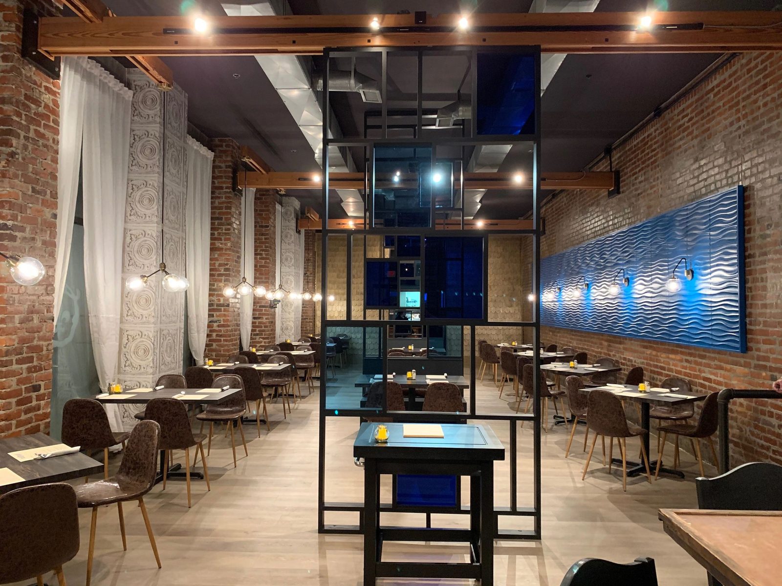 Blue Orleans dining room with exposed brick and blue accent lighting